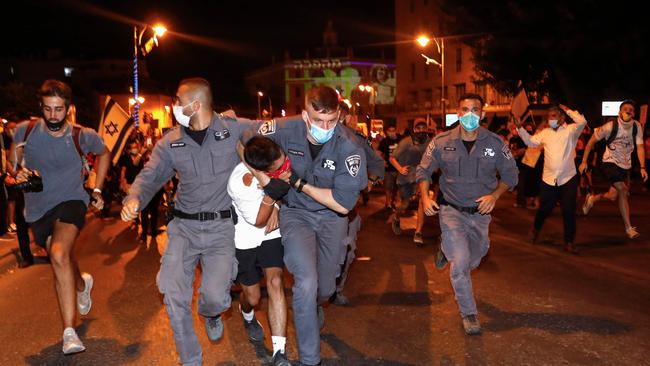 A protester is detained during an demonstration outside Prime Minister Benjamin Netanyahu’s residence in Jerusalem. Picture: AFP