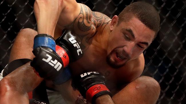 Robert Whittaker (top) dominates Jacare Souza during their April bout.