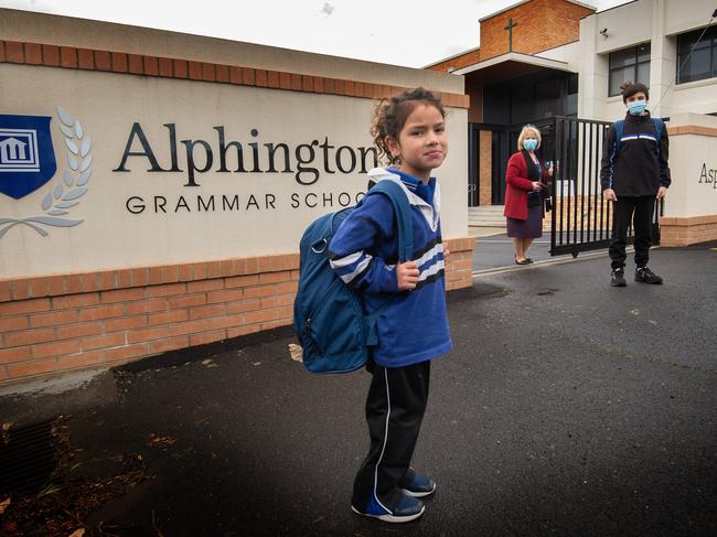 Students and principal Dr Vivianne Nikou in front of the Alphington Grammar School gate. Picture: Tony Gough