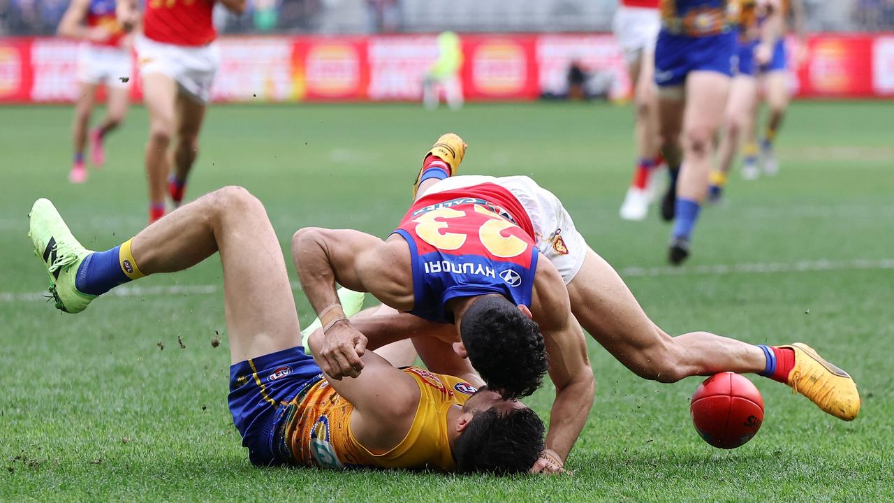 Eagles defender Liam Duggan (bottom) is tackled by Lions star Charlie Cameron. Picture: Will Russell/AFL Photos via Getty Images