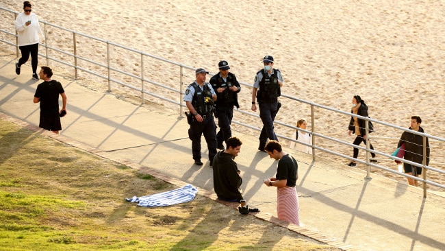 NSW Police are seen patrolling the Bondi Beach boardwalk on July 14 during Greater Sydney's COVID lockdown. Photo: Don Arnold/Getty Images