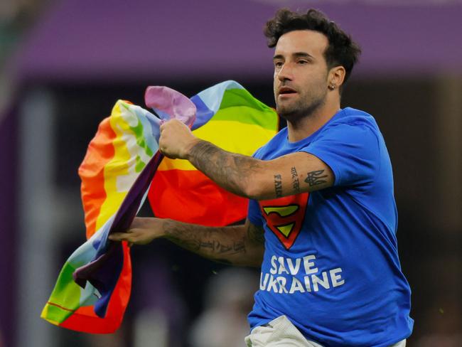 Mario Ferri, 35, who calls himself "The Falcon", and wearing a T-shirt reading "Save Ukraine" invades the pitch waving a rainbow-coloured Peace flag on the pitch during the Qatar 2022 World Cup . Picture: Odd Andersen/AFP