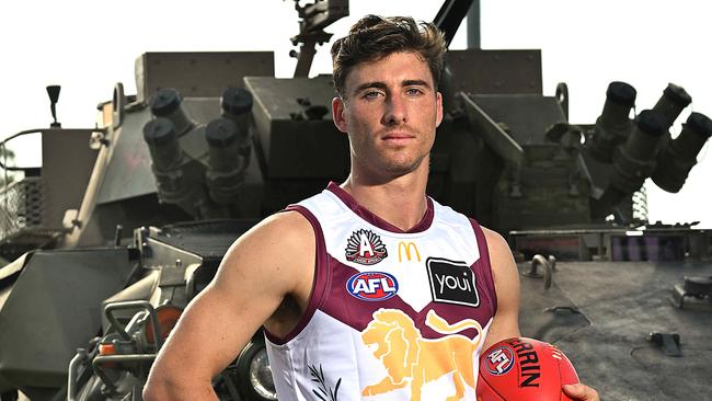 19/4/2024: Brisbane Lions defender Noah Answerth with an Army ASLAV at the Brighton Homes Arena, Springfield.  pic: Lyndon Mechielsen/Courier Mail