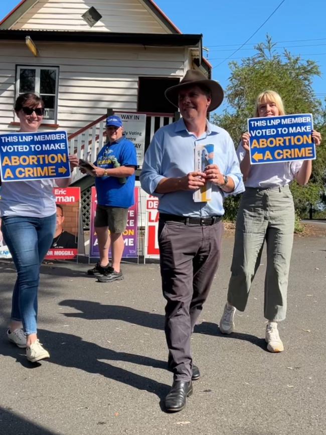 LNP MP Christian Rowan is targeted by pro-choice protesters at a pre-polling booth during the Queensland election. Picture: Supplied