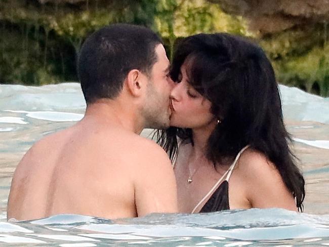 ONE TIME WEB USE FOR NEWS.COM.AU ONLY - FEES APPLY -  PREMIUM EXCLUSIVE: Camila Cabello shows off her stunning slimline figure as she passionately kisses new billionaire boyfriend Henry Junior Chaloub in the Caribbean waters of St Bart?s. The 27-year-old pop princess - who used to date Shawn Mendes - has been linked to Chaaloub, 38, for some time but this is the first occasion the couple has gone public with their romance. Loved-up Camilla, who wore a brown and white string bikini accentuating her slender frame, smiled and laughed as she held hands, kissed and frolicked in the sea with her handsome beau, who wore long navy blue swim shorts. Camila left down her long, chocolate brown locks in perfect beach waves and opted out of any makeup to showcase her natural, radiant beauty. The songstress was reportedly seen ?canoodling? with Lebanese businessman Chalhoub at an Elie Saab fashion show after-party in Riyadh, Saudi Arabia, in late November last year. But, until now, it seems the couple has been been enjoying a low-key romance, flying under the radar of photographers. The Fifth Harmony alum has previously been in relationships with Mendes, Austin Mahone, Louis Tomlinson, Jacob Whitesides and Michael Clifford, per J-14. Chaloub, who used to date Victoria's Secret model Joan Smalls, is a family member of the ultra-rich Dubai-based Chaloub Group, which operates 280 fashion and cosmetic lines across the Middle East, including Chanel, Louis Vuitton, Lacsote, Sephora, Fendi and Michael Kors, and is also believed to do modelling work. The four-time Grammy winner, a Cuban-American, has been candid about her experiences with weight gain, attributing it to the pressures and emotional toll of fame. In a social media post in September 2019, the Senorita singer opened up about her struggle, stating, ?I haven't gone on social media at all with the conscious intention of avoiding things that hurt my feelings,? indicating how public scrutiny affected her. Later on, amid a world turned upside down by the COVID-19 pandemic, she found herself grappling with unexpected challenges, including a significant fluctuation in her weight. Her weight loss journey has been guided by strategic lifestyle changes, including integrating daily walks into her routine, as advised by celebrity fitness trainer Jenna Willis. Walking not only enhances physical fitness but also supports mental well-being, making it a cornerstone of Cabello's approach to shedding pounds effectively. In addition to ramping up her walking regime, she has made conscious decisions to limit alcohol consumption. According to her trainer, alcohol can significantly contribute to unnecessary calorie intake without providing any nutritional benefits. 04 Jan 2025 Pictured: Camila Cabello and Henry Junior Chaloub. Photo credit: Spread Pictures/MEGA TheMegaAgency.com sales@mega.global (Mega Agency TagID: MEGA1250473_017.jpg) [Photo via Mega Agency]