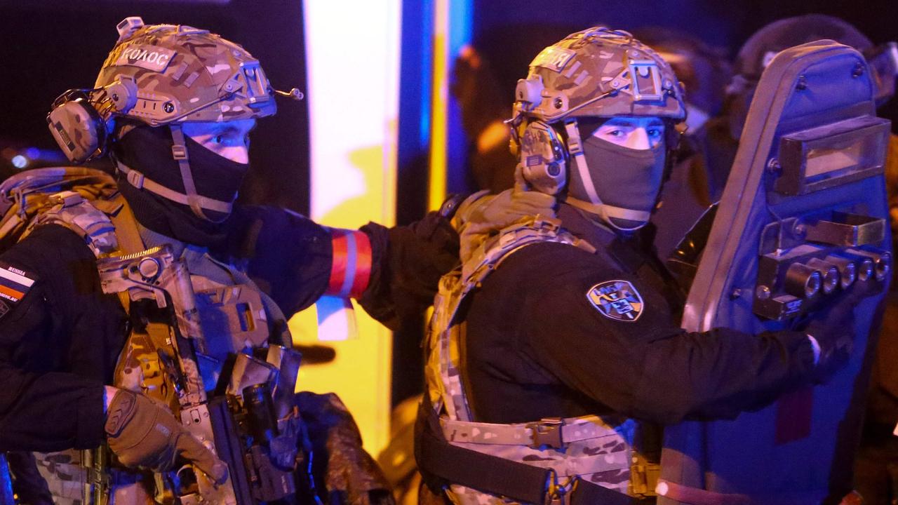 Special operations forces servicemen walk towards the Crocus City Hall concert hall following the shooting. Picture: Sergei Vedyashkin / Moskva News Agency / AFP