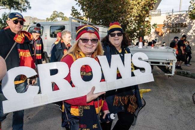 Crows fans Lyn Moore from Morphett Vale and Carol Nash from Happy Valley walking into Adelaide Oval as extras in the film 