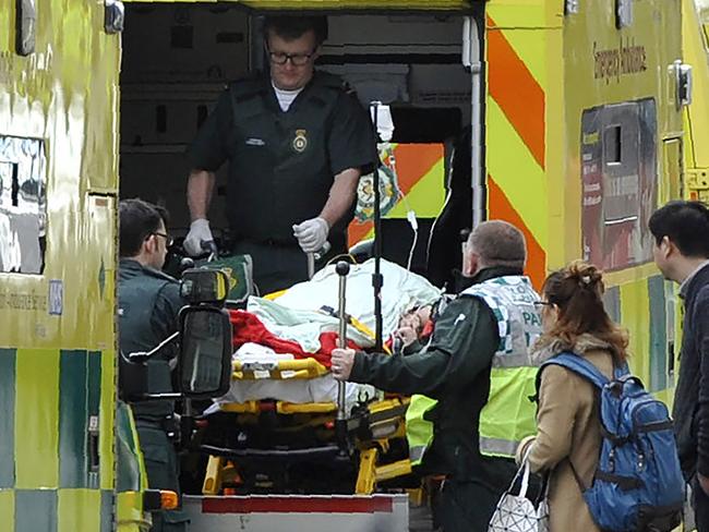 Paramedics load a victim into the back of an ambulance as members of the emergency services work on Westminster Bridge. Picture: Niklas Hallen/AFP Photo