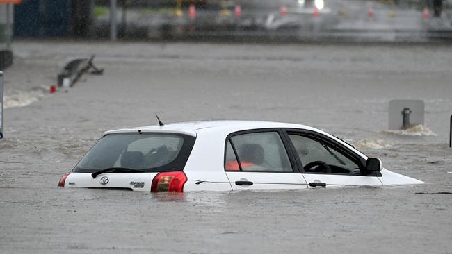 A Toyota Corolla became stuck in floodwater in Widdop st, Nundah. NCA NewsWIRE / John Gass