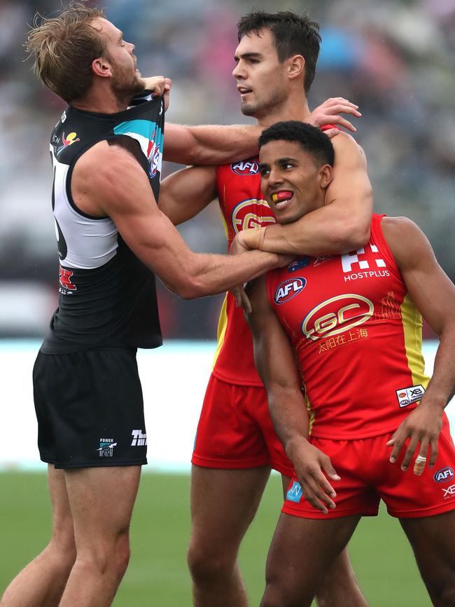 Port Adelaide’s Jack Watts wrestles with Touk Miller and Jarryd Lyons in Shanghai earlier this year. The Power is looking for a new sparring partner for next year’s clash in China. Picture: Sean Garnsworthy/AFL Media/Getty Images