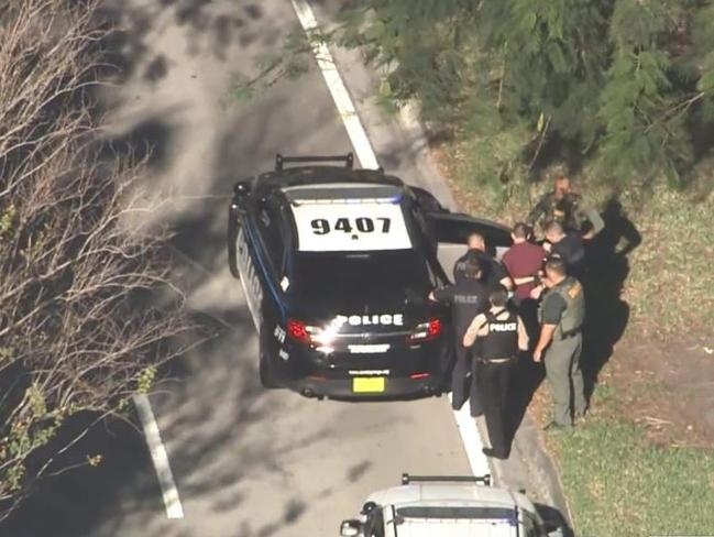 Police handcuff the suspected gunman following the shooting. Picture: NBC