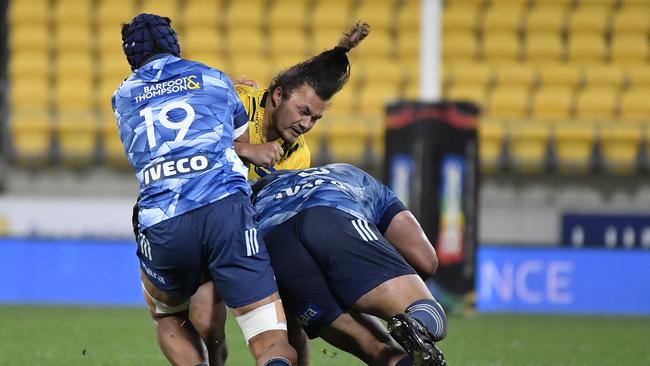 Fraser Armstrong of the Hurricanes is tackled by Gerard Cowley-Tuioti of the Blues during their Super Rugby Aotearoa match. Picture: Getty Images