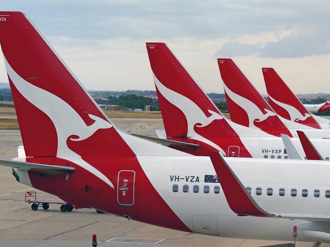 MELBOURNE, AUSTRALIA - FEBRUARY 25: Qantas aeroplanes wait at Melbourne Tullamarine Airport on February 25, 2014 in Melbourne, Australia. On Thursday Qantas will announce their half year results, media reports suggest part of those announcements will include a large number of job cuts and the sale of their Melbourne terminal. (Photo by Scott Barbour/Getty Images)