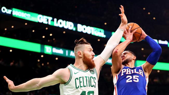 Aron Baynes (L) puts the pressure on fellow Australian Ben Simmons. Picture: AFP