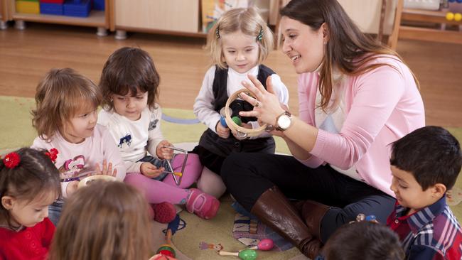 A childcare worker and children in a daycare centre.