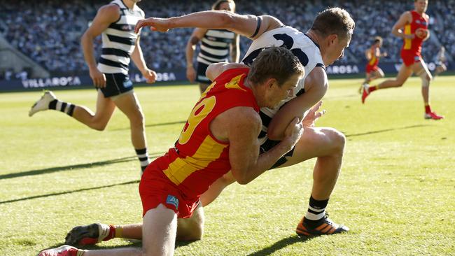 Nick Holman applies the tackle that left Mitch Duncan concussed. Picture: Darrian Traynor/AFL Photos/Getty Images