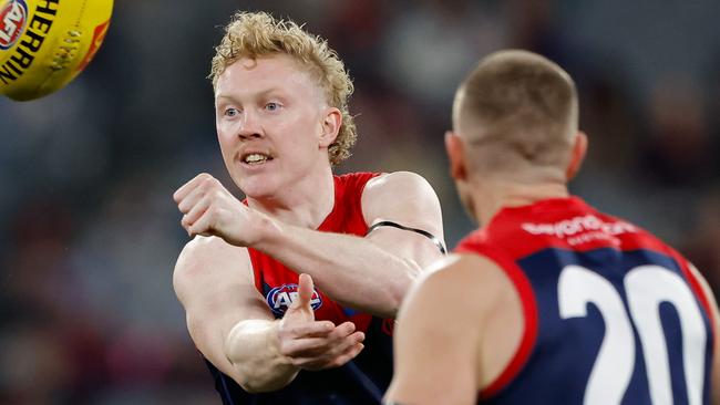 MELBOURNE, AUSTRALIA - JUNE 22: Clayton Oliver of the Demons handpasses the ball during the 2024 AFL Round 15 match between the Melbourne Demons and the North Melbourne Kangaroos at The Melbourne Cricket Ground on June 22, 2024 in Melbourne, Australia. (Photo by Dylan Burns/AFL Photos via Getty Images)