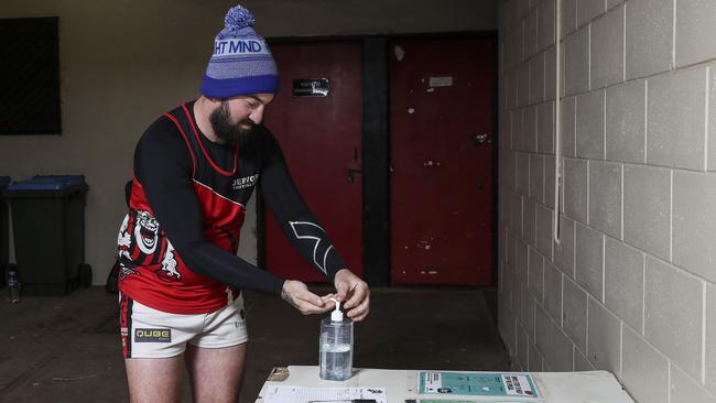 Players use hand sanitiser and must sign in on a sheet before training. Picture: Sarah Reed.