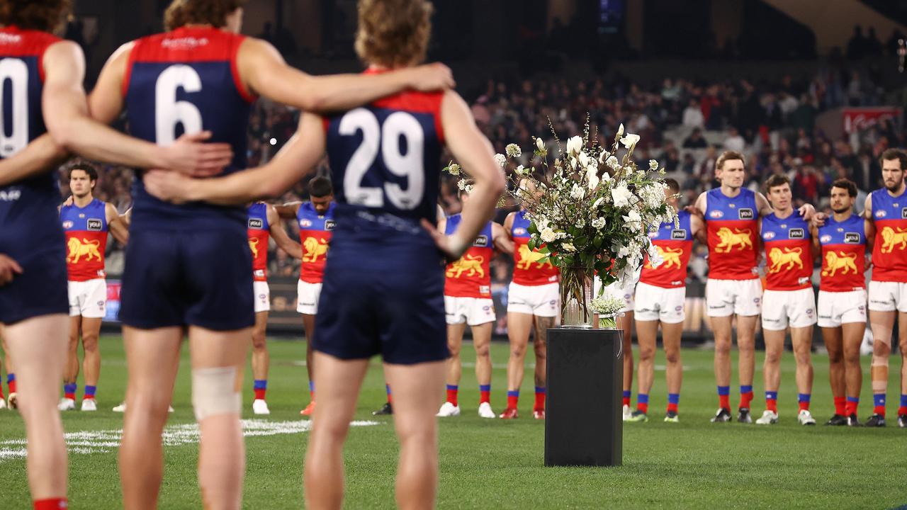 Players from Melbourne and Brisbane Lions line up to honour the late Queen Elizabeth II at the MCG. Picture: Michael Klein