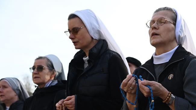 Nuns pray the holy rosary at the statue of John Paul II outside the Gemelli hospital where Pope Francis is hospitalised. Picture: AFP