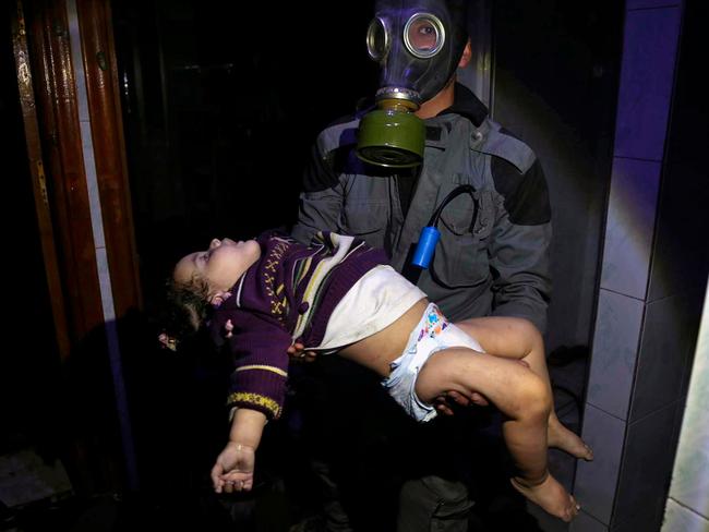 An image from the Syrian Civil Defense White Helmets showing a rescue worker carrying a child caught up in an alleged chemical weapons attack. Picture: Syrian Civil Defense White Helmets via AP, File.