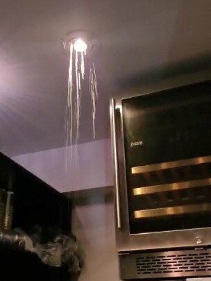 Flooding from an above apartment flows through the light fixture. Picture: Supplied