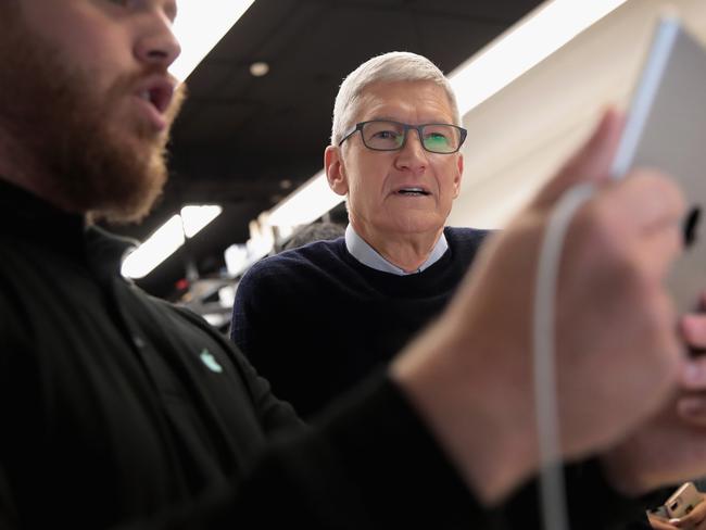 Apple CEO Tim Cook gets a demonstration of an app during an event held to introduce the new 9.7-inch Apple iPad at Lane Tech College Prep High School in Chicago. Picture: Scott Olson/Getty Images/AFP