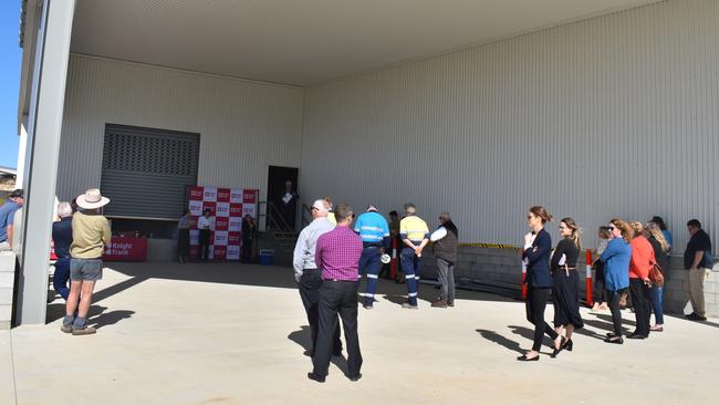 The auction crowd at the site of the 85 per cent completed pineapple processing factory at Hidden Valley.