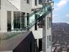 This undated artist's rendering provided by Overseas Union Enterprise Limited shows a glass slide 1,000 feet above the ground off the side of the U.S. Bank Tower in downtown Los Angeles. The 45-foot-long attraction is part of a $50 million renovation that will also put a bar and open-air observation deck on the top floors of the 72-story building. (Michael Ludvik/ OUE Ltd. via AP)