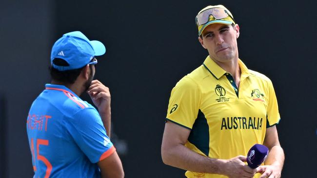 Australia's captain Pat Cummins (R) chats with India's Rohit Sharma. Picture: AFP