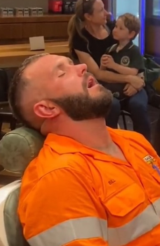 Billy fell asleep while getting a hair cut after a long day at work.