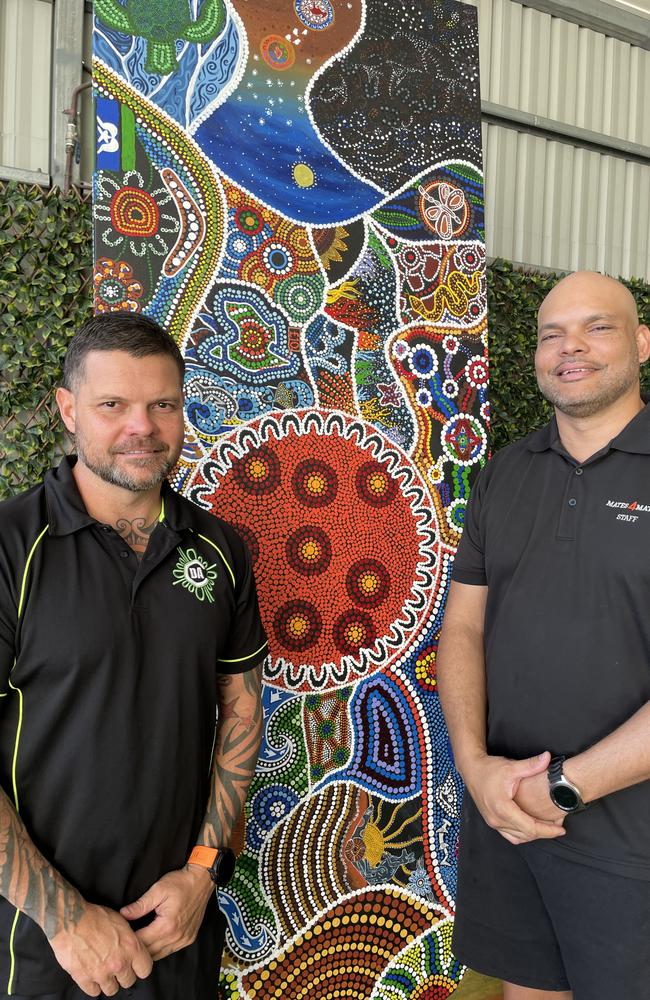 Artist Chris Gray and Mates4Mates liaison officer Coco Quirke with the finished painting.