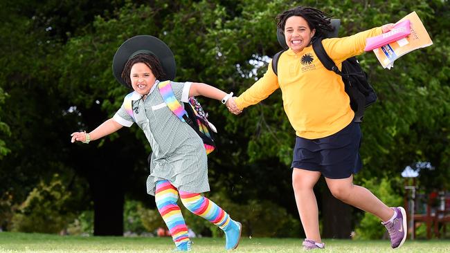 Sisters Kaya and Aisha Abdi are jumping for joy that school is returning. Picture: Josie Hayden