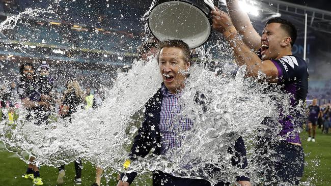 Craig Bellamy is drenched after the Storm’s grand final win.