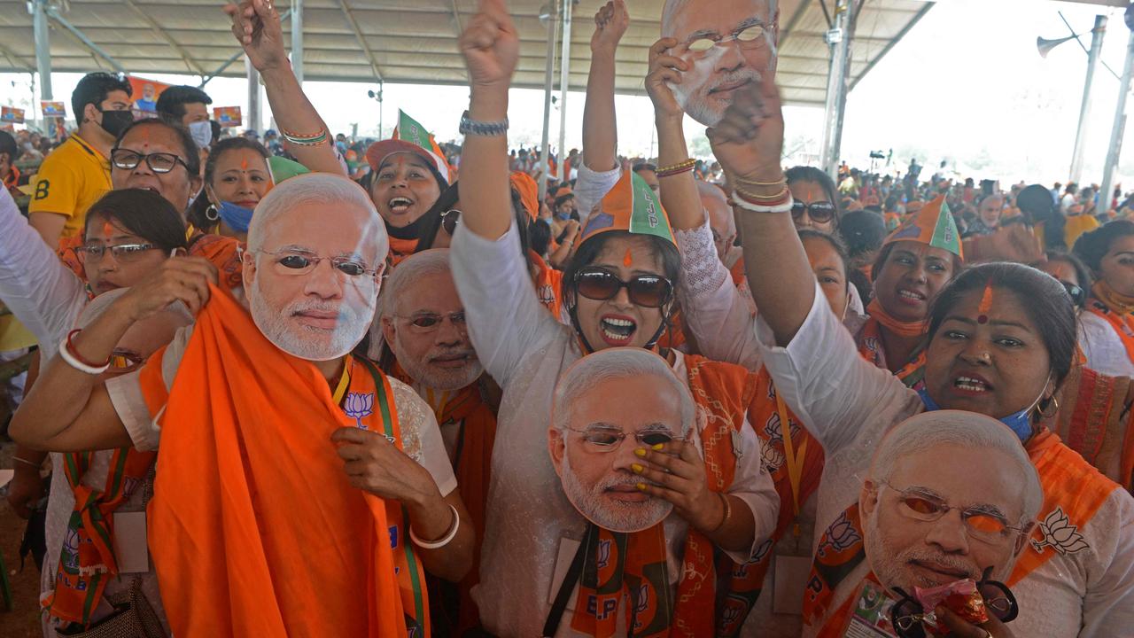 Supporters of Bharatiya Janata Party (BJP) wearing face cutouts of Indian Prime Minister Narendra Modi, but not masks, at a public rally on April 10. Picture: Diptendu Dutta/AFP