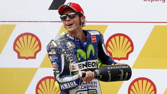 Yamaha MotoGP rider Rossi of Italy sprays champagne on the podium after placing third at the Malaysian Motorcycle Grand Prix ...