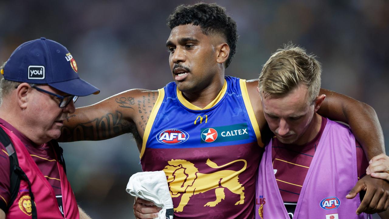 Keidean Coleman of the Lions is assisted by trainers during the 2024 AFL Opening Round match between the Brisbane Lions and the Carlton Blues. Photo: Russell Freeman/AFL Photos via Getty Images.