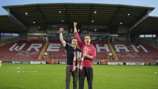 Wrexham co-owners Rob McElhenney, left, and Ryan Reynolds pose with trophy. AP Photo/Jon Super.