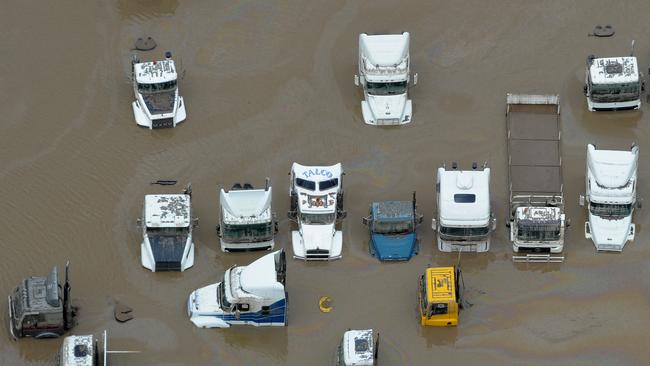 Transport trucks sit in floodwaters in the Brisbane suburb of Rocklea on Friday, Jan. 14, 2011.
