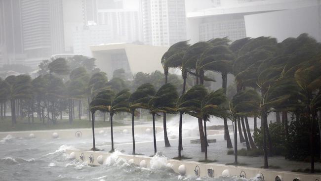 Waves crash over a seawall from Biscayne Bay. Picture: AP