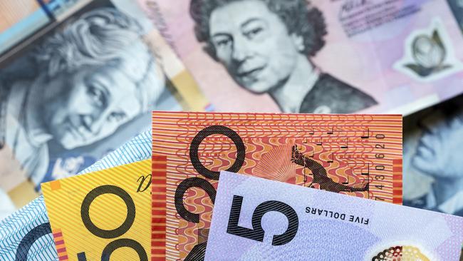 Australian money background. Focus on foreground, blurred faces beneath. Notes generic