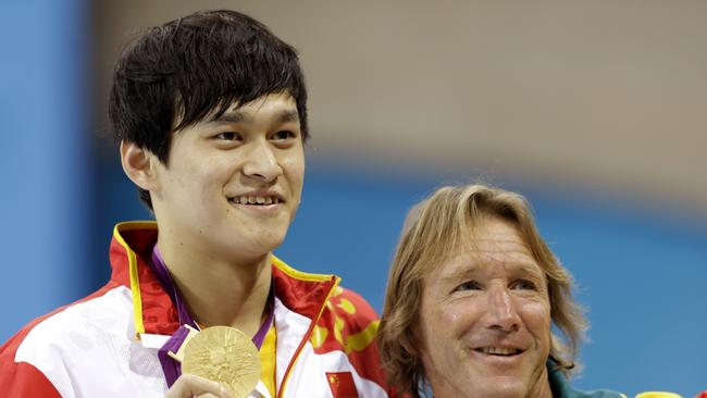 04/08/2012 WIRE: China's Sun Yang poses with his coach, Australian Denis Cotterell after winning the gold medal in the men's 1500-meter freestyle swimming final at the Aquatics Centre in the Olympic Park during the 2012 Summer Olympics in London, Saturday, Aug. 4, 2012. (AP Photo/Lee Jin-man) Pic. Ap