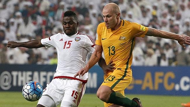 UAE's Ismail al-Hammdai (L) vies with Australia's Aaron Mooy.