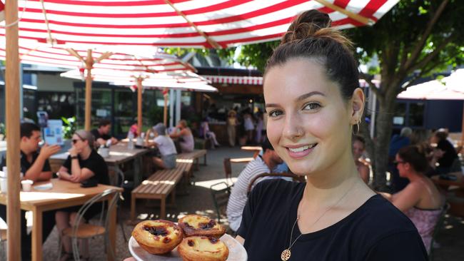 Staff member Hannah Summers with some Portuguese tarts. Picture Glenn Hampson