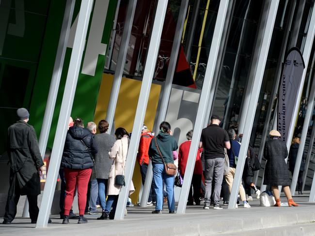 People queue at the Melbourne Convention and Exhibition Centre for their Covid vaccination. Picture: Andrew Henshaw