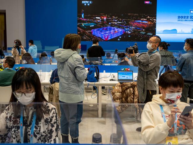 Reporters work during the opening ceremony of the Beijing 2022 Winter Olympic Games at the main media centre in Beijing on February 4, 2022. (Photo by AFP) / China OUT