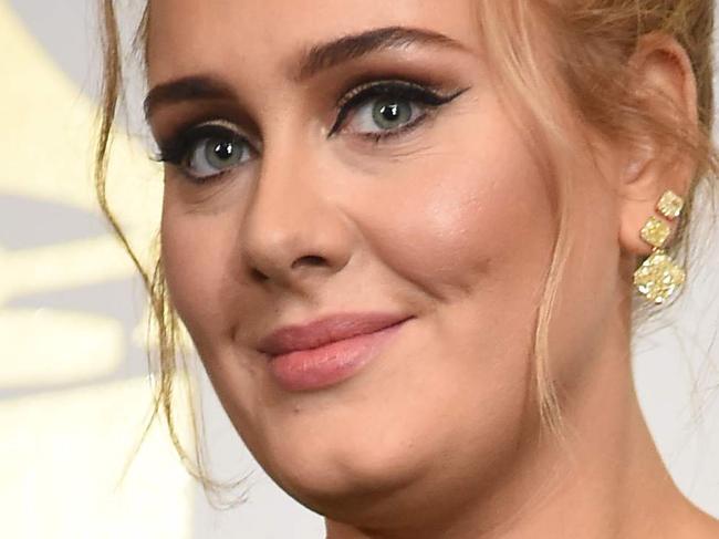 (FILES) This file photo taken on February 12, 2017 shows  Adele posing in the press room with her trophies during the 59th Annual Grammy music Awards on February 12, 2017, in Los Angeles. Adele has confirmed years of speculation that she is married. The English singer has been in a long-term relationship with Simon Konecki, a former financier who founded drop4drop, a charity that presses for global access to clean drinking water. She confirmed their status at a concert in Brisbane, Australia on March 5, 2017. / AFP PHOTO / Robyn BECK
