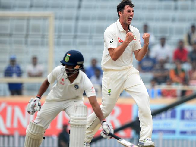Australia's Pat Cummins (R) reacts next to India's Wriddhiman Saha (L) during the fourth day of the third Test cricket match between India and Australia at the Jharkhand State Cricket Association (JSCA) Stadium Complex in Ranchi on March 19, 2017. ----IMAGE RESTRICTED TO EDITORIAL USE - STRICTLY NO COMMERCIAL USE----- / GETTYOUT---- / AFP PHOTO / SAJJAD HUSSAIN / ----IMAGE RESTRICTED TO EDITORIAL USE - STRICTLY NO COMMERCIAL USE----- / GETTYOUT