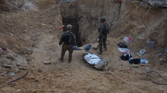 Israeli soldiers drag the body of Mohammed Sinwar from the tunnel where he was found. Picture: Israeli Defence Forces.