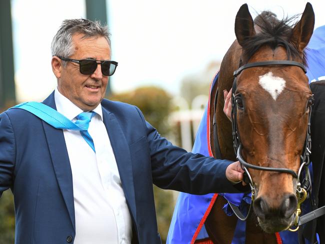 Trainer Lindsey Smith poses after Jockey Brad Rawiller rode Black Heart Bart to victory in race 7, the Underwood Stakes, during Underwood Stakes Day at Caulfield Racecourse in Melbourne, Sunday, September 29, 2019. (AAP Image/Vince Caligiuri) NO ARCHIVING, EDITORIAL USE ONLY